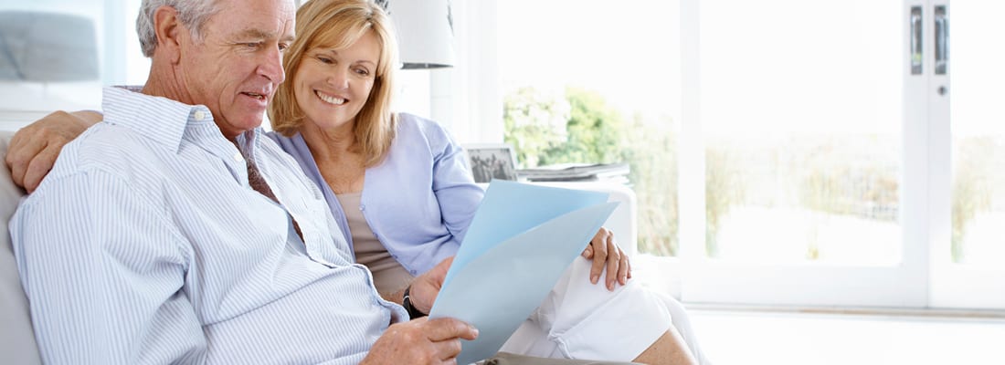 older couple smiling in their home