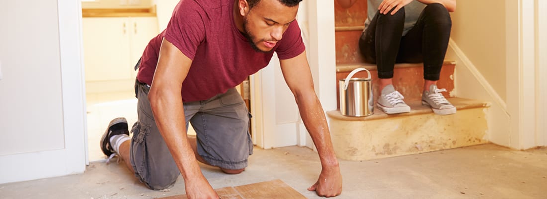 man doing DIY kneeling on floor