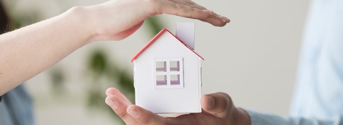 people holding small house model